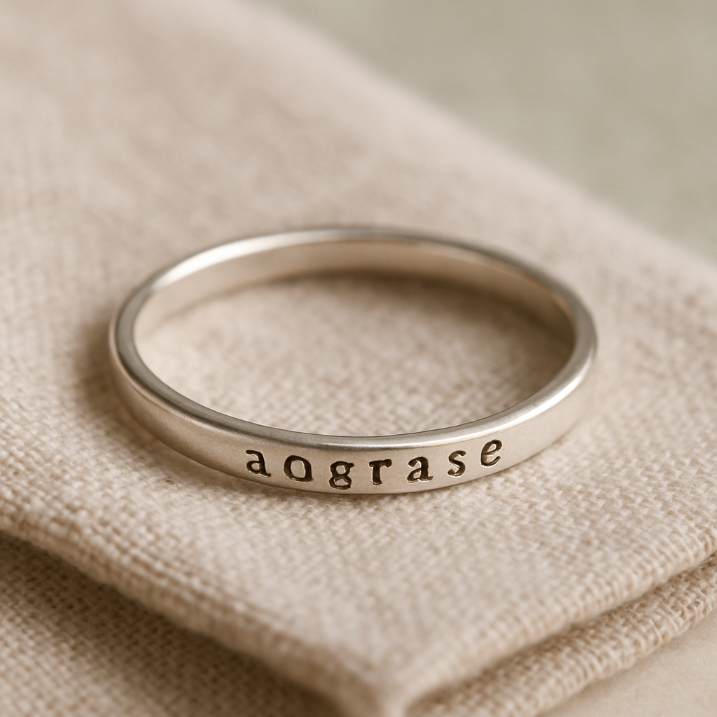 Engraved sterling silver stacking band on oatmeal linen