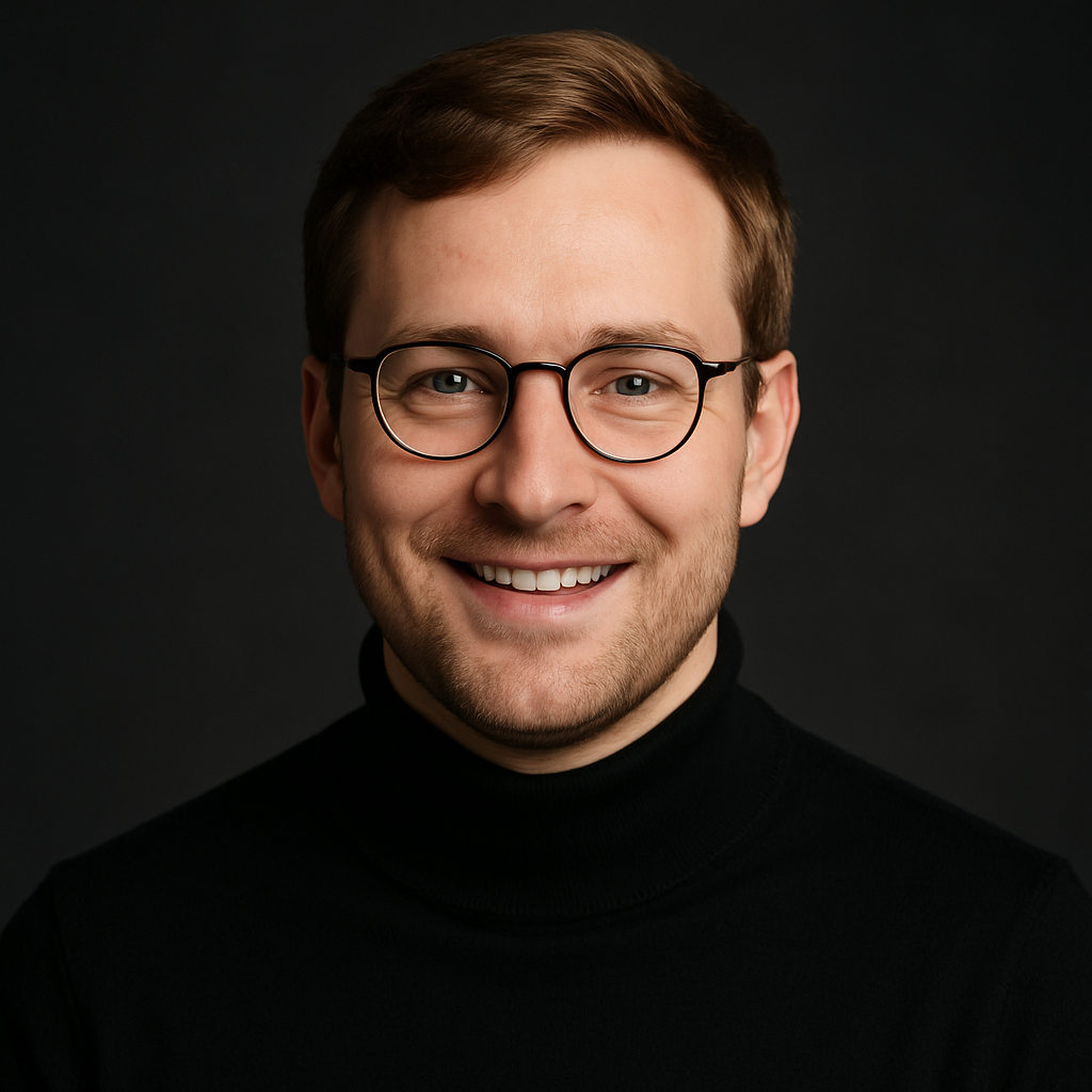 Portrait of a white male agency partner with light brown hair, round glasses, and a black turtleneck, smiling in a studio